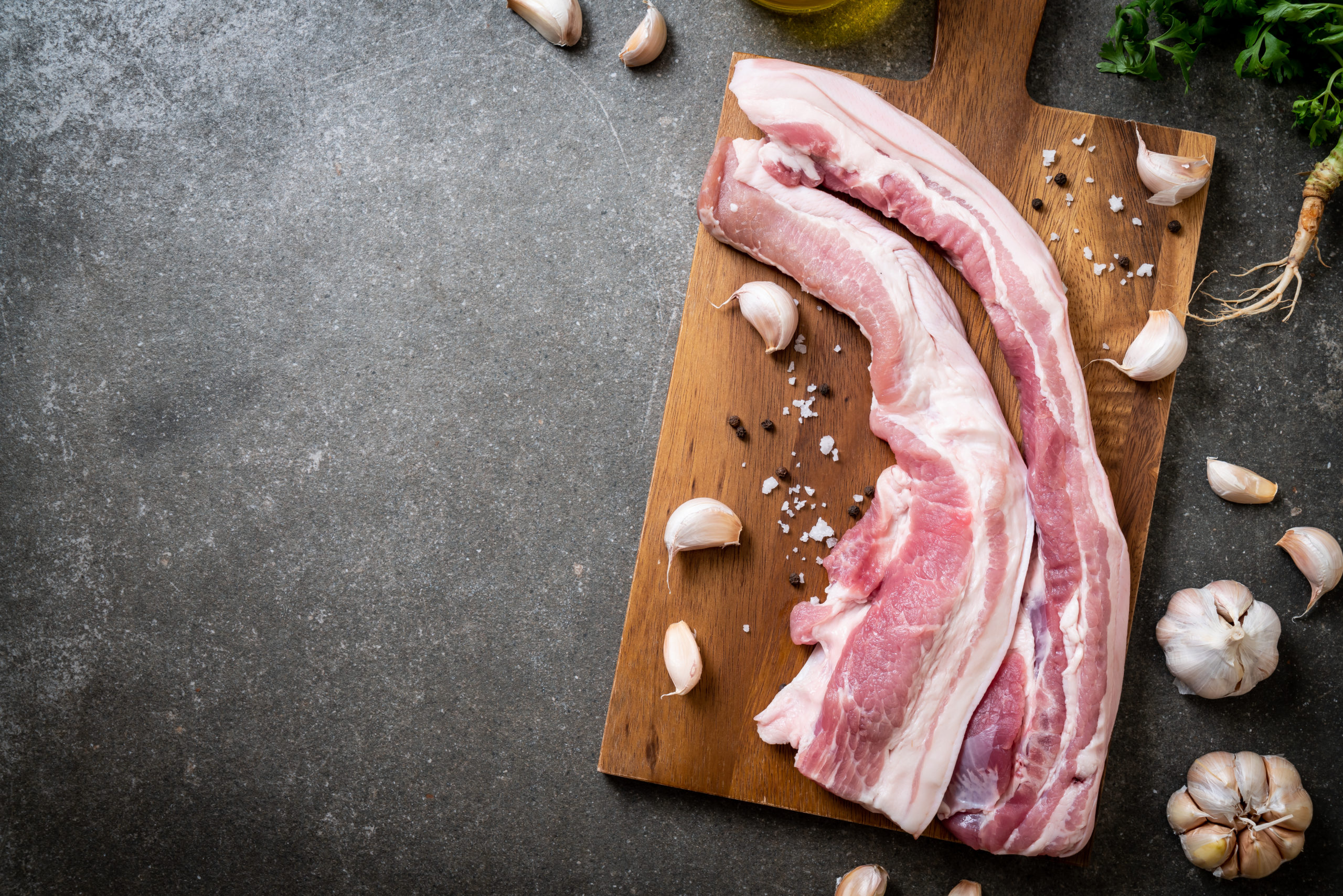 fresh raw streaky pork on wood board with ingredient